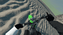 a person riding a bike on a sandy road