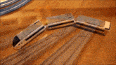 a toy train is going down a track on a wooden table .