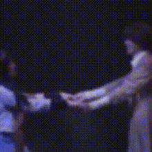 a blurry image of a man and woman dancing on a stage .