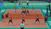 a volleyball game is being played on a court with an advertisement for leasetake.pl in the background