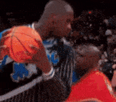two men are playing basketball and one of them is wearing a jersey that says magic