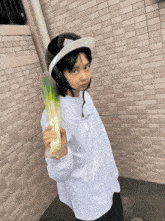 a person wearing a helmet and holding a large vegetable