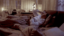 a man laying on a bed with a cell phone