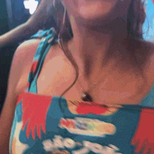 a woman wearing a blue and red dress with the word hooters on the front