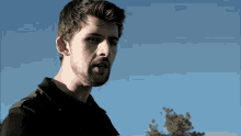 a man with a beard wearing a black shirt