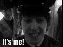a black and white photo of a young boy smiling with the words `` it 's me '' written on the bottom .