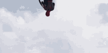 a man in a spiderman costume is holding a captain america shield