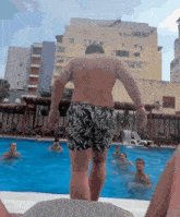 a man is jumping into a swimming pool