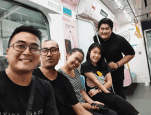 a group of people sitting on a train with a sign that says ' a20 '