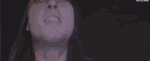 a close up of a person smoking a cigarette in the dark .