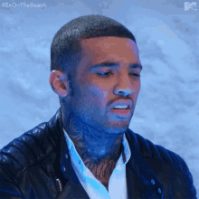 a man with a tattoo on his neck is wearing a black leather jacket and a white shirt