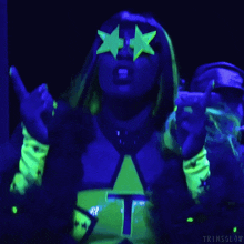 a woman in a glow in the dark outfit with a star on it