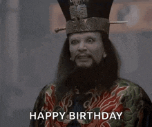 a man with a beard is wearing a hat and a robe and says happy birthday .