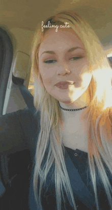 a woman in a car with the words feeling cute above her