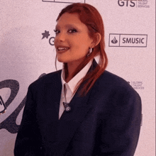 a woman standing in front of a sign that says smmusic