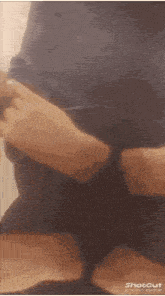 a person is cutting their hair with a pair of scissors in a shot cut video .