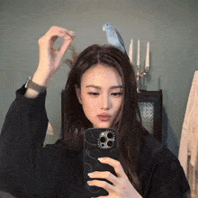 a woman taking a picture of herself with a casetify phone case