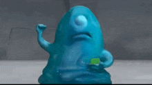 a blue cartoon character is holding a green object in its mouth