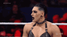 a female wrestler is standing in a wrestling ring with the words wwe raw on the bottom