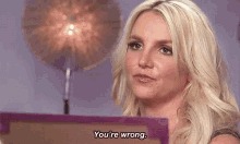 a blonde woman says you 're wrong in front of a drum