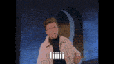 a man in a white jacket is standing in front of a brick wall with the word iiii on the screen