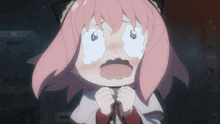 a girl with pink hair is making a funny face
