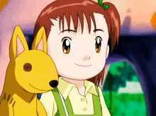 a little girl is holding a stuffed animal that has the letter o on it