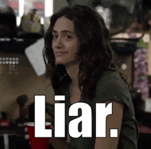a woman holding a red cup with the word liar written above her
