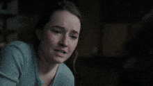 a woman with a sad look on her face is next to a sign that says are just f * * king wrong