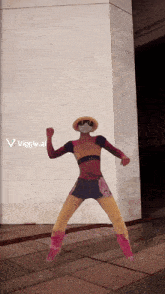 a person in a superhero costume is standing in front of a wall with a viggle.ai logo on the bottom