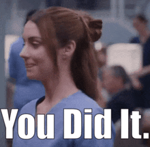 a woman in a blue scrub is smiling with the words " you did it " written below her