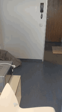 a room with a lamp and a microwave that has a plug in it