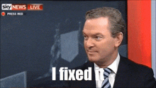 a man in a suit and tie says " i fixed it " on a tv screen