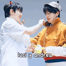 a couple of boys standing next to each other with the words luci y andrea on the bottom