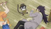 a group of anime characters laying on the floor with a cat in the background