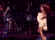 a close up of a woman dancing on a stage in a dark room .