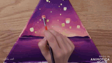 a person is painting a purple triangle with a brush and the words made in animatica on the bottom