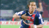 a soccer player wearing a force jersey runs on the field