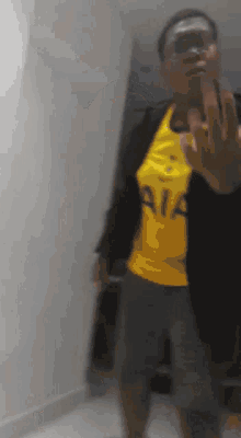 a man wearing a yellow shirt that says aia on it