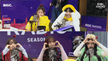 a group of girls are making hearts with their hands in front of microphones at idol radio