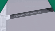a green and white triangle with the number 30th anni on it