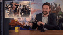 a man in a suit sits at a table with a yellow mug that says " make a wish "