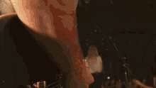 a man is playing an acoustic guitar with a strap around his shoulder