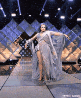 a drag queen is dancing on a stage in a ghost costume .