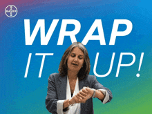 a woman giving the middle finger in front of a banner that says wrap