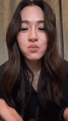 a close up of a woman making a face