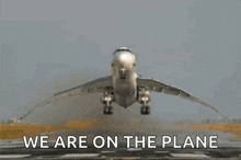 an airplane is taking off from a runway and the words we are on the plane are below it