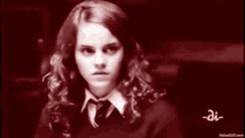 a black and white photo of a girl in a school uniform and tie