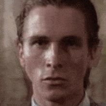 a close up of a man wearing glasses and a suit and tie .