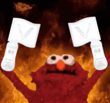 elmo from sesame street is holding up two signs that say ' vanner '